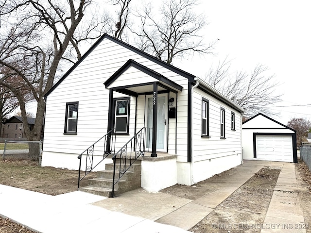 view of front of house featuring a garage and an outdoor structure