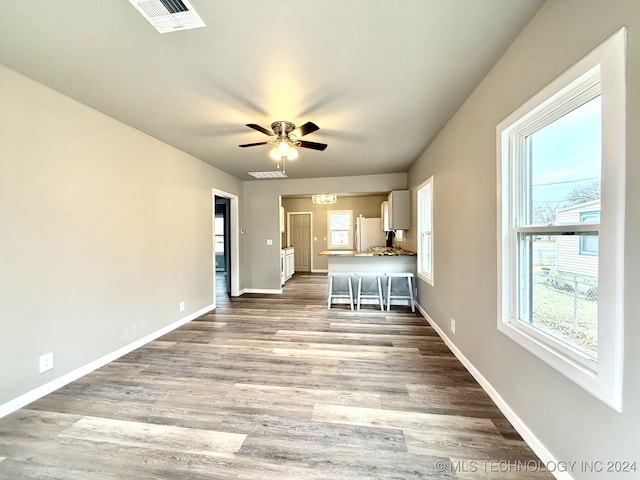 unfurnished living room featuring ceiling fan and light wood-type flooring