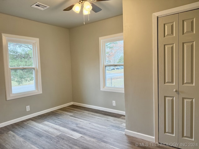 spare room with ceiling fan and wood-type flooring