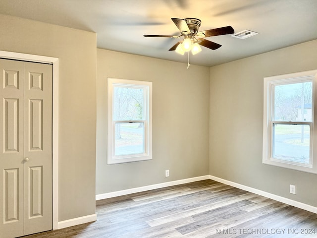 unfurnished bedroom featuring hardwood / wood-style floors and ceiling fan