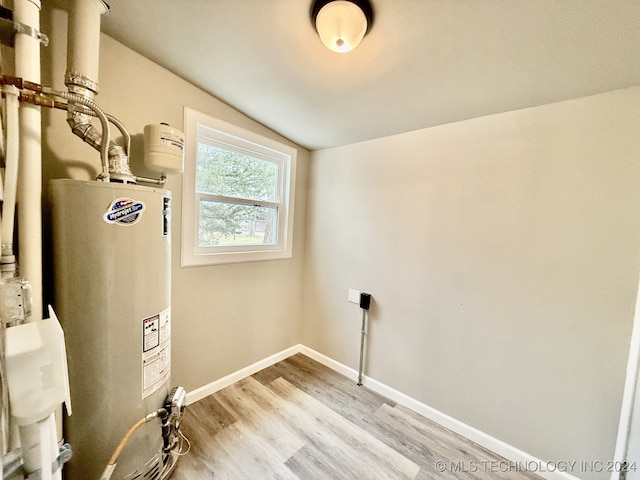 utility room featuring gas water heater