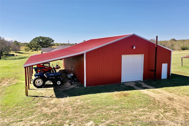 view of outbuilding with a garage and a yard