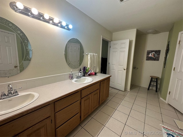 bathroom with tile patterned floors and vanity