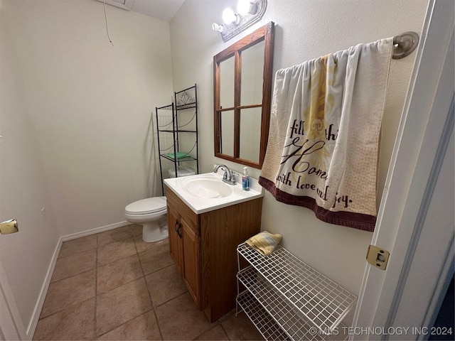 bathroom with tile patterned flooring, vanity, and toilet