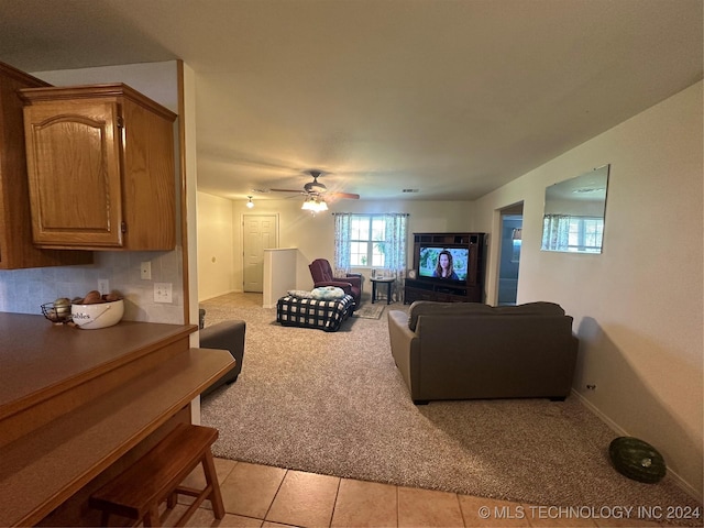 tiled living room with ceiling fan