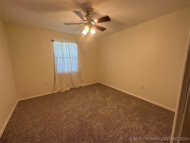 spare room featuring ceiling fan and carpet floors