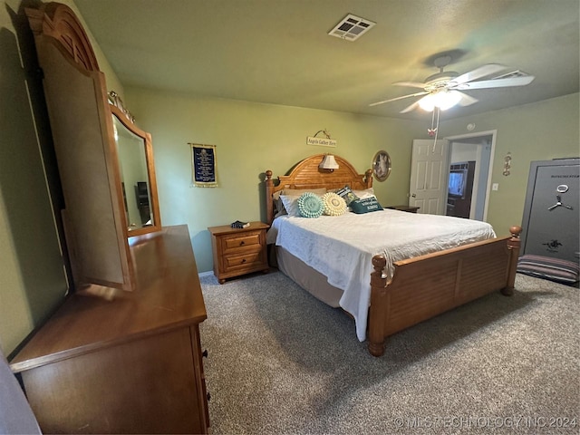 bedroom with ceiling fan and dark carpet