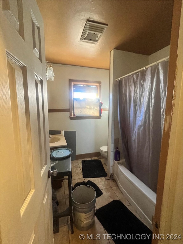 full bathroom featuring tile patterned flooring, vanity, toilet, and shower / tub combo with curtain