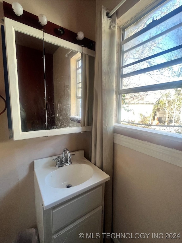 bathroom with plenty of natural light and vanity