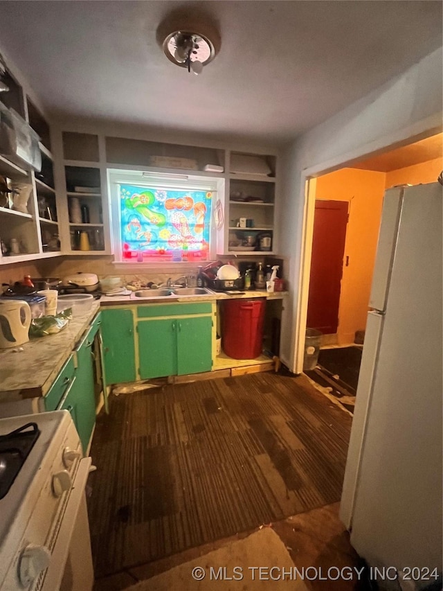 kitchen featuring built in shelves, white appliances, sink, and green cabinetry