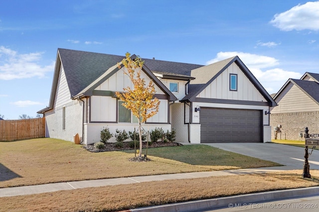 view of front of house featuring a front lawn and a garage