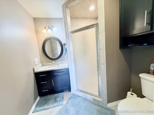 bathroom featuring tile patterned floors, toilet, an enclosed shower, and vanity