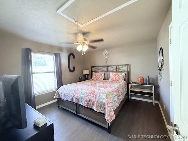 bedroom with ceiling fan, dark hardwood / wood-style flooring, and a textured ceiling