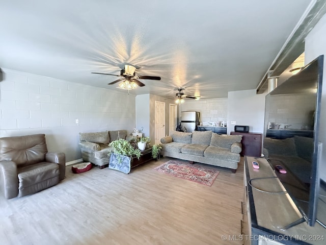 living room featuring wood-type flooring and brick wall