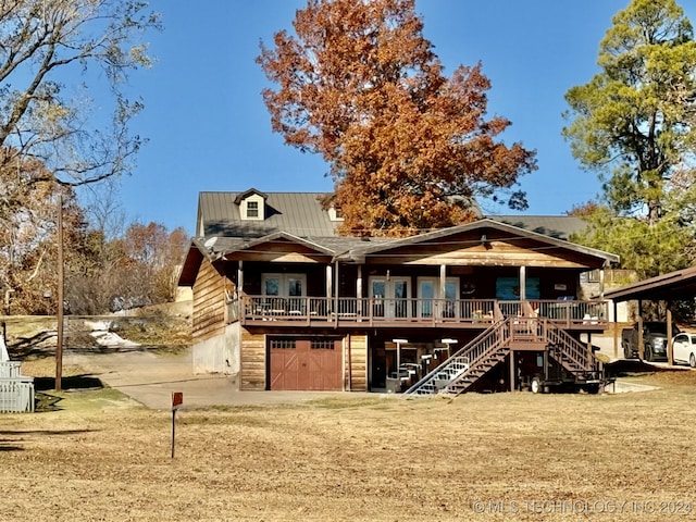 rear view of house with a garage and french doors