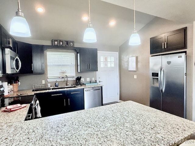 kitchen with pendant lighting, stainless steel appliances, vaulted ceiling, and sink