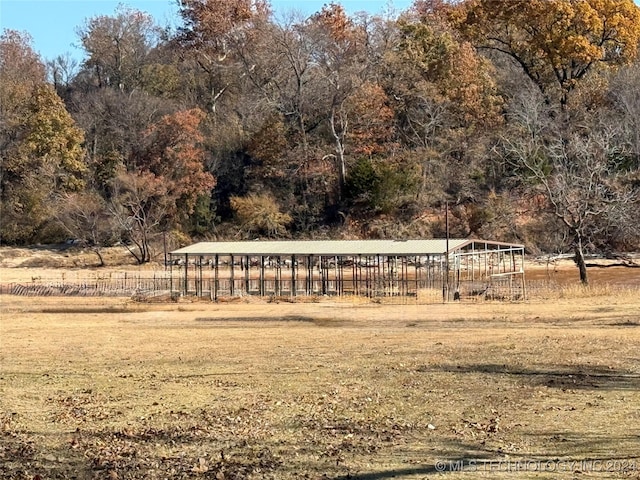 view of home's community with a rural view and a lawn