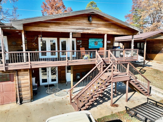 view of front of house with a wooden deck and french doors