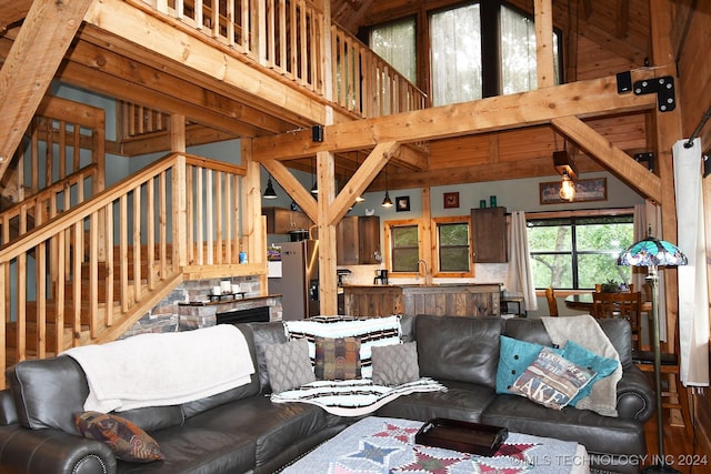 living room featuring beamed ceiling, high vaulted ceiling, and sink