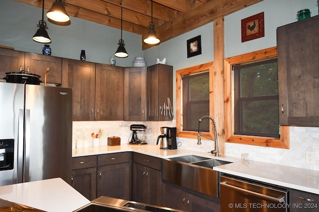 kitchen featuring pendant lighting, sink, stainless steel appliances, and tasteful backsplash