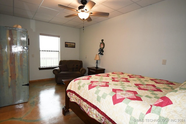 bedroom with a paneled ceiling and ceiling fan