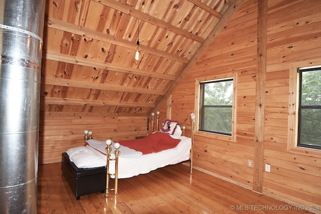 bedroom featuring vaulted ceiling with beams, dark wood-type flooring, and wood walls