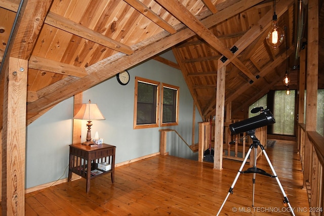 game room with hardwood / wood-style floors, lofted ceiling with beams, and wooden ceiling