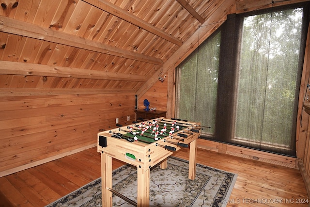 playroom with vaulted ceiling with beams, wood walls, hardwood / wood-style floors, and wooden ceiling