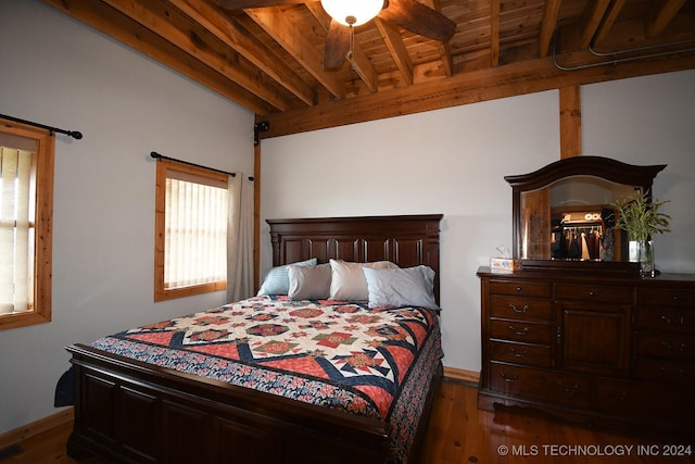 bedroom with beam ceiling, dark hardwood / wood-style flooring, ceiling fan, and wood ceiling