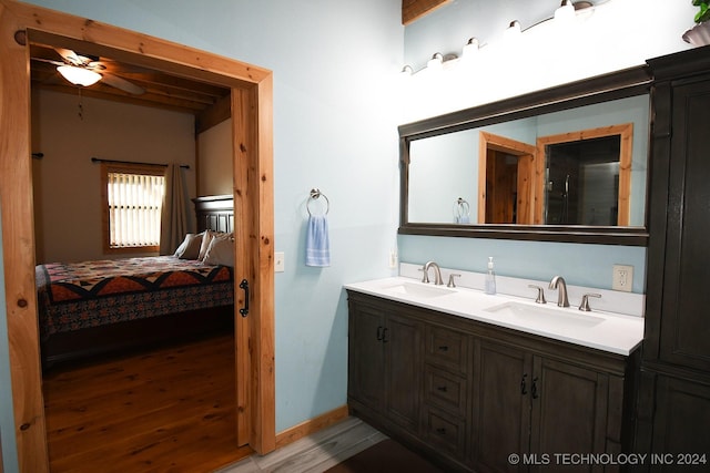 bathroom with hardwood / wood-style floors, vanity, and ceiling fan