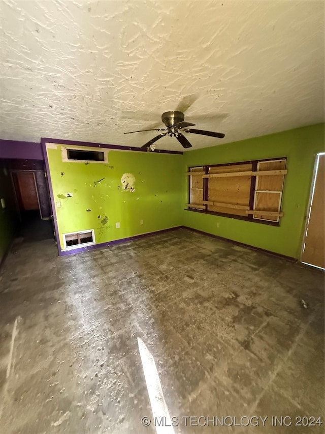 unfurnished living room featuring a textured ceiling and ceiling fan