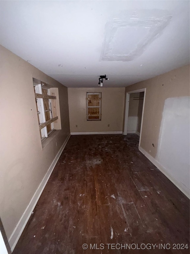 spare room with dark hardwood / wood-style flooring