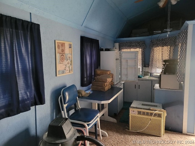 kitchen featuring carpet floors and lofted ceiling