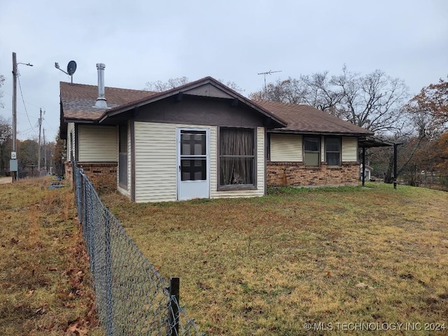 rear view of property with a yard