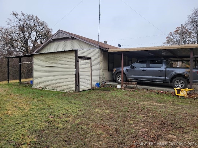 view of property exterior with a carport and a yard