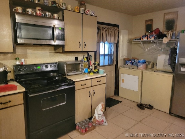 kitchen with black electric range, light tile patterned floors, separate washer and dryer, and decorative backsplash