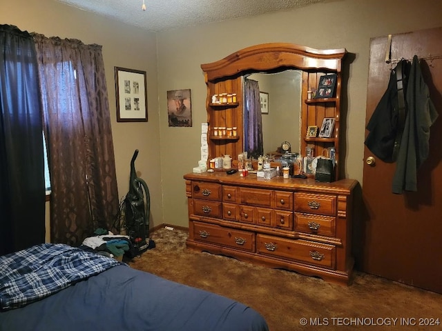 carpeted bedroom with a textured ceiling