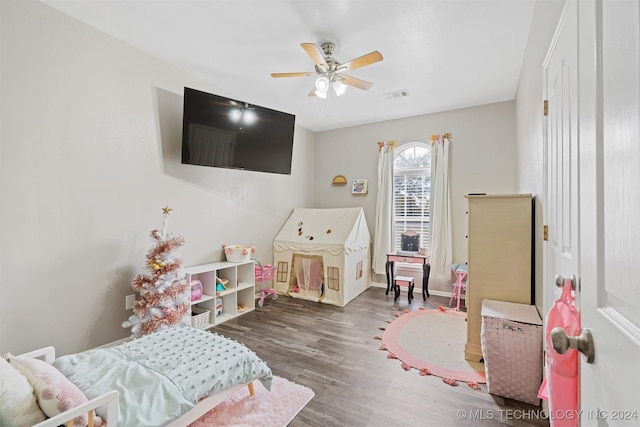 recreation room featuring ceiling fan and dark hardwood / wood-style floors