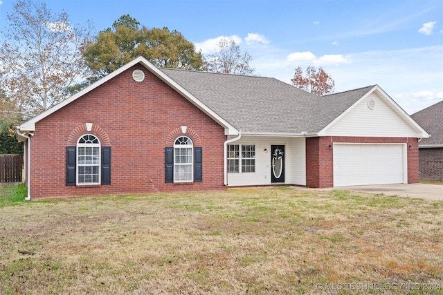 view of front of property with a front lawn and a garage