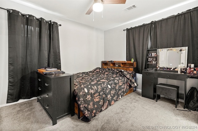 bedroom with ceiling fan and light colored carpet