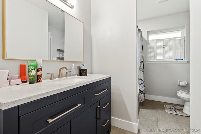 bathroom featuring tile patterned floors, vanity, and toilet