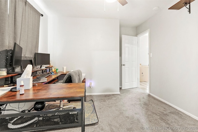 carpeted home office with ceiling fan