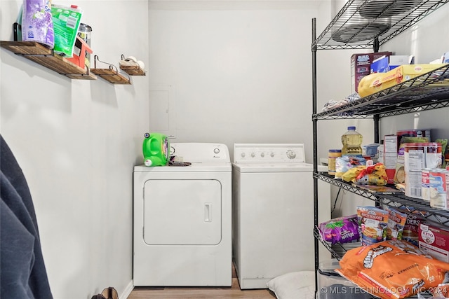 clothes washing area featuring washer and dryer and light hardwood / wood-style floors