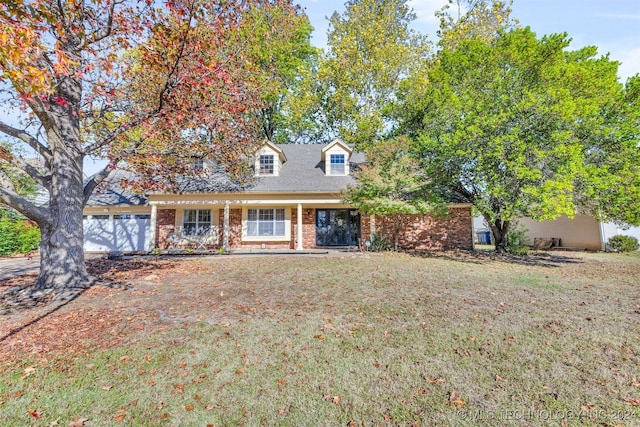 cape cod home with a front yard