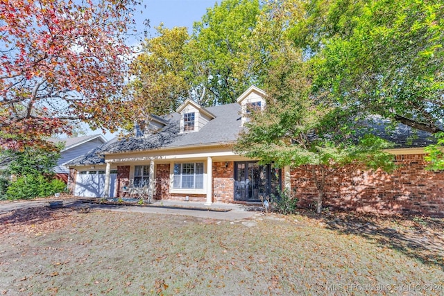 cape cod home with a porch and a garage