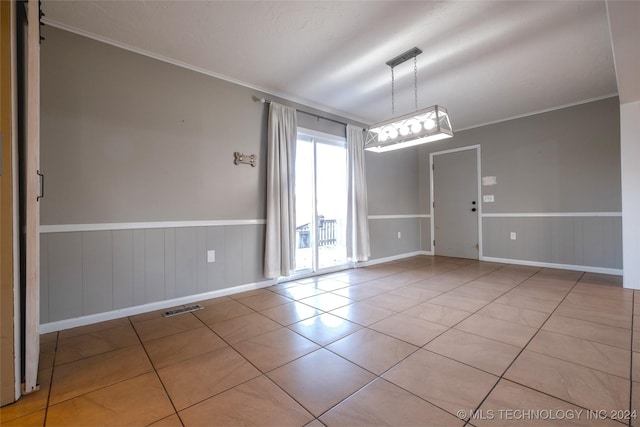 tiled spare room with ornamental molding