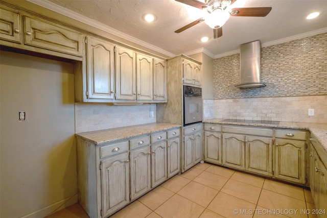 kitchen featuring tasteful backsplash, black electric stovetop, oven, and wall chimney range hood