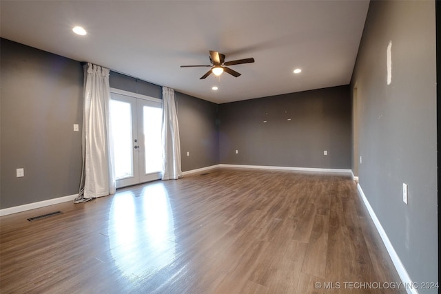 empty room with ceiling fan, french doors, and hardwood / wood-style flooring