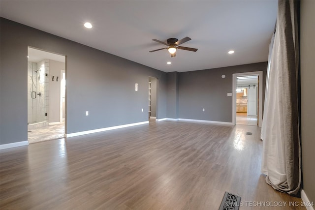 unfurnished room featuring ceiling fan and hardwood / wood-style flooring