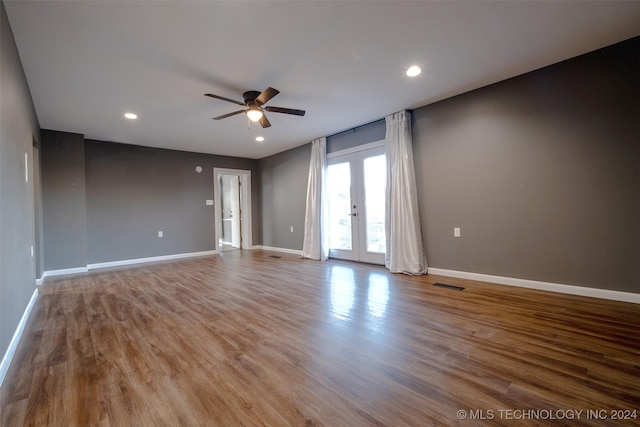 spare room with ceiling fan, french doors, and hardwood / wood-style flooring